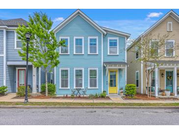 Charming two-story home with a striking blue exterior and a cheerful yellow front door at 1656 Indy Dr, North Charleston, SC 29405