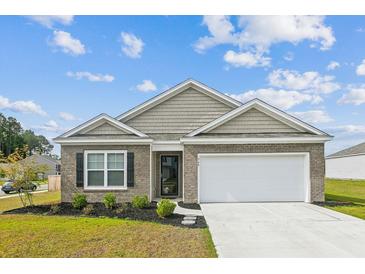 Charming brick home with a two-car garage and well-maintained landscaping at 369 Spruce Ivy St, Moncks Corner, SC 29461