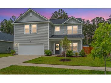 Charming two-story home with grey siding, well-manicured lawn, and attached two-car garage at 4314 Cotton Flt Rd, Summerville, SC 29485