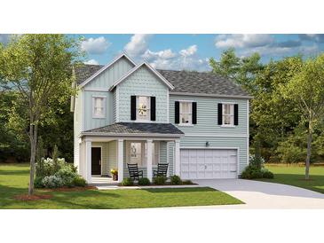 Charming two-story home with light blue siding, a welcoming front porch and attached two-car garage at 1055 Tea Time Dr, Summerville, SC 29485