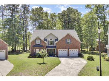 Charming two-story brick home with a well-manicured lawn and a two-car garage at 123 Dasharon Ln, Goose Creek, SC 29445