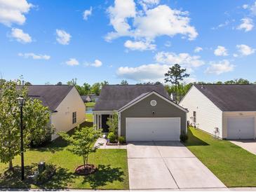 Charming single-Gathering home featuring a two-car garage and landscaped front yard, perfect for curb appeal at 187 Brittondale Rd, Summerville, SC 29485