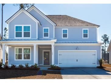 Charming two-story home featuring a light blue exterior, attached garage, and welcoming front porch at 193 Belfort Pl, Summerville, SC 29486