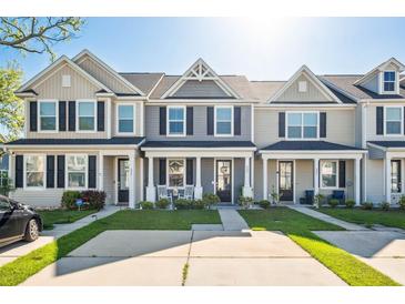 Charming townhouses with inviting front porches, landscaping, and black shutters, offering curb appeal at 202 Kirkland St, Goose Creek, SC 29445