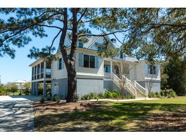 Charming home with a raised foundation, elevated screened porch, and a staircase leading to the front door at 2312 Rushland Landing Rd, Johns Island, SC 29455