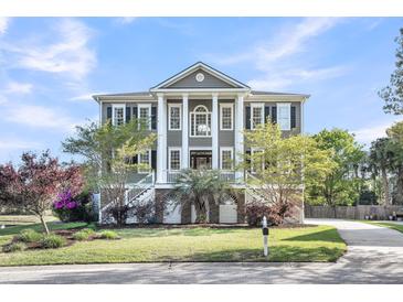 Elegant two-story home featuring stately columns, dual staircases and beautiful landscaping at 2340 Salt Wind Way, Mount Pleasant, SC 29466