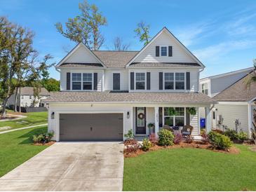 Charming two-story home with a well-manicured lawn, attached garage, and welcoming front porch at 2823 Dearmin Dr, Mount Pleasant, SC 29466