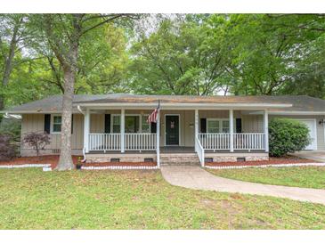 Charming single-story home with covered front porch and manicured lawn in a wooded neighborhood at 306 Fairlawn Drive, Moncks Corner, SC 29461