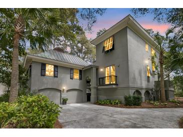 Stunning two-story home with lush landscaping, garage, and inviting curb appeal at 410 Ocean Oaks Ct, Kiawah Island, SC 29455