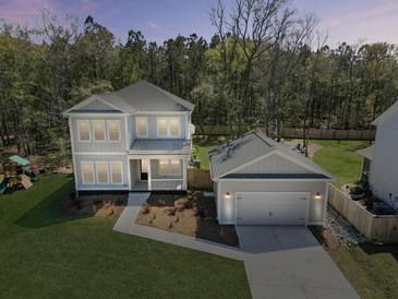 Beautiful two-story home featuring lush front yard and a detached garage at 4209 Royal Harbor Rd, Hollywood, SC 29449