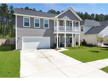 Charming two-story home with a spacious driveway and manicured lawn at 4310 Cotton Flat Rd, Summerville, SC 29485