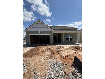 Single-story home featuring a two-car garage and a charming covered front porch at 625 Marsh Cove Cir, Summerville, SC 29486