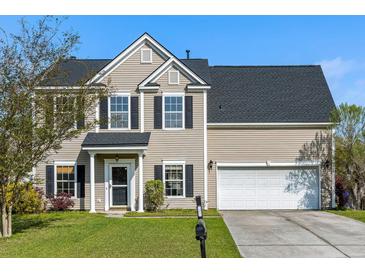 Charming two-story home featuring a well-manicured lawn, attached garage, and classic black shutters at 712 Bent Hickory Rd, Charleston, SC 29414