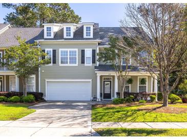 Charming townhome with a well-manicured lawn and attached garage, featuring classic architectural details at 120 Fresh Meadow Ln, Mount Pleasant, SC 29466