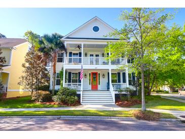 Charming two-story home with double front porches, red front door and beautifully landscaped yard at 147 Musket Loop, Summerville, SC 29483