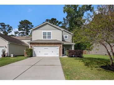 Charming two-story home with stone accents, attached two car garage, and a well maintained lawn at 1723 Indaba Way, Charleston, SC 29414