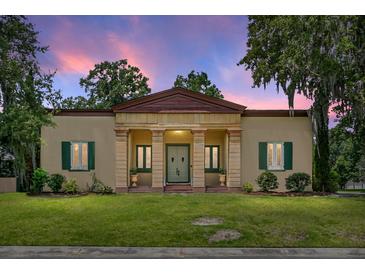 Stately home featuring a columned portico entrance, shutters, and lush lawn at 2 Leone Ln, Hanahan, SC 29410