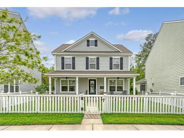 Charming two-story home with a welcoming front porch and a white picket fence at 227 Oak View Way, Summerville, SC 29483