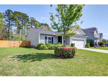 Charming single-Gathering home featuring a well-maintained lawn and a two-car garage at 2914 Glenarden Dr, Charleston, SC 29414