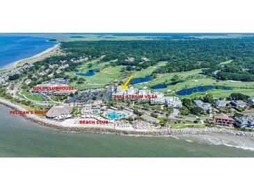 Stunning aerial view of the Atrium Villa complex, surrounded by lush golf courses and ocean views at 2933 Atrium Villa Dr # 33, Seabrook Island, SC 29455