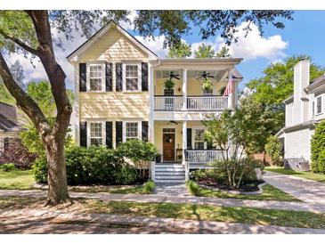 Charming two-story home with a welcoming front porch and beautiful landscaping at 3023 Macbeth Creek Dr, Charleston, SC 29414