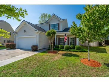 Charming two-story home featuring a manicured lawn, a two-car garage, and inviting curb appeal at 3363 Kinross Ct, Summerville, SC 29485