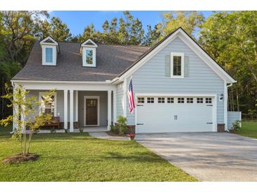 Charming exterior elevation featuring a two-car garage, dormer windows and a inviting covered front porch at 4263 Hugh Bennett Dr, Johns Island, SC 29455