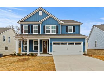 Charming blue two-story home with a front-facing two-car garage and well-manicured lawn at 503 Fiskdale Cir, Summerville, SC 29486