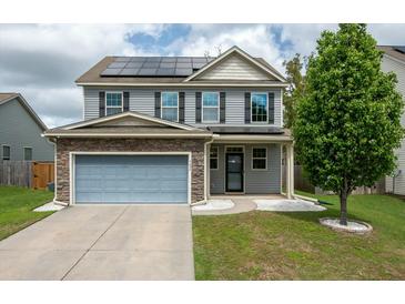 Charming two-story home with a two-car garage, solar panels, and well-maintained landscaping at 7638 Haywood St, North Charleston, SC 29418