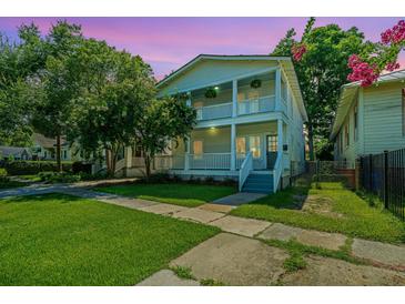 Charming two-story home featuring double porches and a beautifully landscaped yard, perfect for relaxing outdoors at 1011 Ashley Ave, Charleston, SC 29403