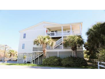 Coastal home exterior with palm trees and covered decks offering outdoor living spaces at 126 Jungle Rd # 7B, Edisto Beach, SC 29438
