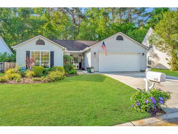 Charming single-story home with a well-manicured lawn and beautiful landscaping, showcasing its inviting curb appeal at 1722 S Nicole Pl, Charleston, SC 29414