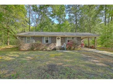 Charming single-story brick home with well-maintained landscaping and a welcoming entrance at 202 Oak Cir, Walterboro, SC 29488