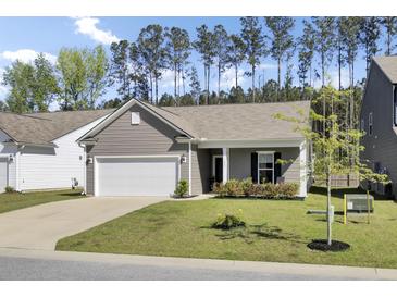 Charming single-story home with a two-car garage, manicured lawn, and beautiful landscaping at 222 Hayworth Rd, Summerville, SC 29486