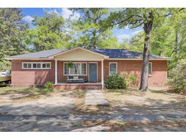 Charming single-story brick home with a welcoming front porch and well-maintained landscaping at 237 Cypress Dr, Walterboro, SC 29488