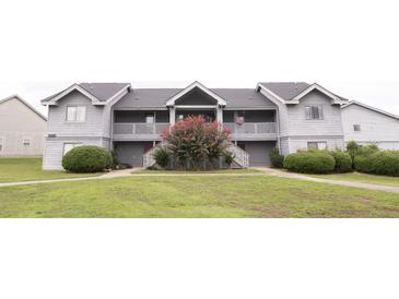 Gray two-story condo building with well-maintained lawn and mature landscaping at 2402 Riverridge Ct, Moncks Corner, SC 29461