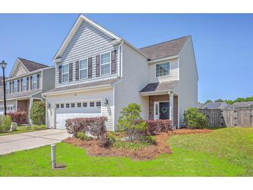 Charming two-story home with a well-manicured lawn and an attached two-car garage at 255 Longford Dr, Summerville, SC 29483