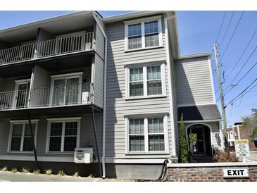 Exterior view of a multi-story home with a private balcony and an inviting entrance at 259 E. Bay St # 1A, Charleston, SC 29401