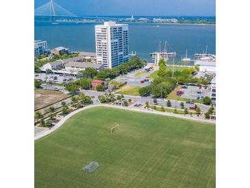 Scenic aerial view features a grassy recreation field, harbor, and high-rise buildings at 330 Concord St # Th 9, Charleston, SC 29401