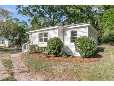 Charming cottage-style home with fresh white exterior and landscaping at 3484 Johan Blvd, Johns Island, SC 29455