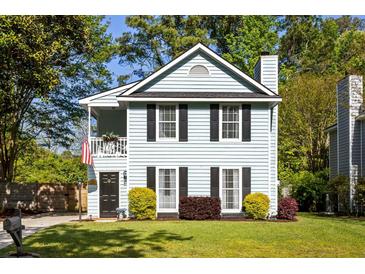 Charming two-story home with a light blue exterior, black shutters, and a cozy front porch at 540 Castle Hall Rd, Mount Pleasant, SC 29464