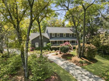Stately two-story home with a welcoming front porch and driveway lined with mature trees at 739 Wildwood Rd, Charleston, SC 29412