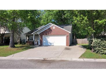 Charming single-story home featuring a brick facade, a well-maintained lawn, and an attached two-car garage at 8107 Old London Rd, North Charleston, SC 29406