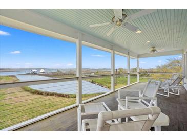 Enjoy a spacious porch with ceiling fans and beautiful waterfront views at 1214 Tabby Dr, Folly Beach, SC 29439