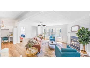 Bright living room boasts natural light, wood floors, fireplace, and stylish furnishings at 118 Regent St, Summerville, SC 29483