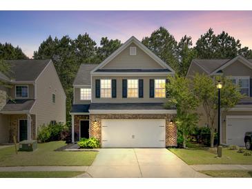 Charming home with brick and siding exterior, two-car garage and inviting curb appeal at 134 Longford Dr, Summerville, SC 29483