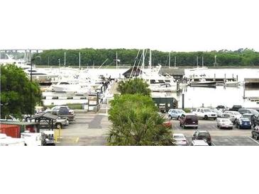 Waterfront marina view showcasing boat slips, various boats, and parking at 14 Lockwood Dr # 2E, Charleston, SC 29401
