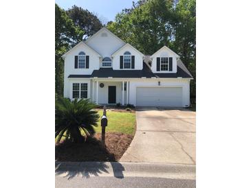 Charming two-story home featuring black shutters, an attached two-car garage, and a well-manicured lawn at 1496 Cypress Pointe Dr, Mount Pleasant, SC 29466