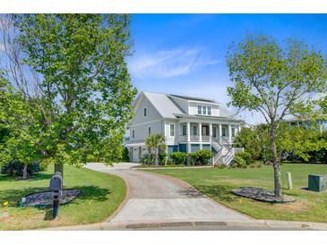 Charming two-story home features a manicured lawn, driveway, and inviting front porch at 1500 Bower Ln, Johns Island, SC 29455