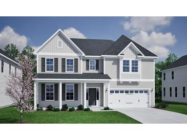 Inviting two-story home featuring a classic design, gray siding, dark shutters, and a well-manicured lawn at 152 Seaton St, Summerville, SC 29486